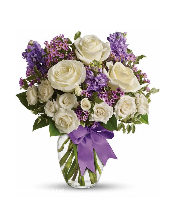 white roses and purple flowers in a vase.